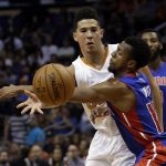 Phoenix Suns guard Devin Booker passes the ball as Detroit Pistons guard Ish Smith (14) defends during the fourth quarter of an NBA basketball game Wednesday, Nov. 9, 2016, in Phoenix. The Suns defeated the Pistons 107-100. (AP Photo/Rick Scuteri)