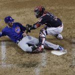 Chicago Cubs' Ben Zobrist is safe at home as Cleveland Indians catcher Roberto Perez puts on a late tag during the fourth inning of Game 7 of the Major League Baseball World Series Wednesday, Nov. 2, 2016, in Cleveland. (AP Photo/David J. Phillip)
