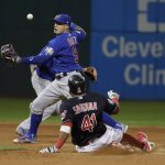 Chicago Cubs' Javier Baez can't handle the ball as Cleveland Indians' Carlos Santana slides safely into second during the third inning of Game 7 of the Major League Baseball World Series Wednesday, Nov. 2, 2016, in Cleveland. (AP Photo/David J. Phillip)