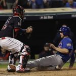 Chicago Cubs' Ben Zobrist is safe at home as Cleveland Indians catcher Roberto Perez puts on a late tag during the fourth inning of Game 7 of the Major League Baseball World Series Wednesday, Nov. 2, 2016, in Cleveland. (AP Photo/David J. Phillip)