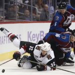 Arizona Coyotes center Tyler Gaudet, front, is pulled to the ice by Colorado Avalanche defenseman Nikita Zadorov, (16) of Russia, as defenseman Erik Johnson covers in the second period of an NHL hockey game Tuesday, Nov. 8, 2016, in Denver. (AP Photo/David Zalubowski)