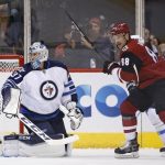 Winnipeg Jets goalie Connor Hellebuyck (37) looks for the puck after Arizona Coyotes' Radim Vrbata scores a goal as Coyotes' left wing Jamie McGinn (88) creates a screen during the first period of an NHL hockey game Thursday, Nov. 10, 2016, in Glendale, Ariz. (AP Photo/Ross D. Franklin)