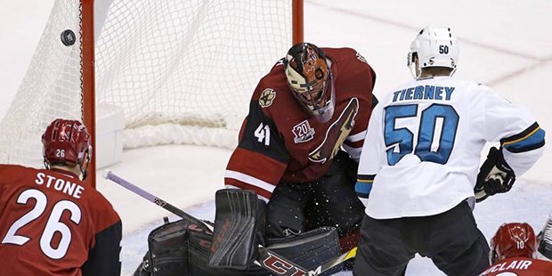 Arizona Coyotes goalie Mike Smith (41) makes a save on a shot by San Jose Sharks center Chris Tiern...