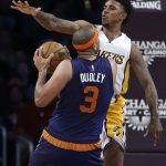 Los Angeles Lakers guard Nick Young (0) defends against Phoenix Suns forward Jared Dudley (3) going to the basket during the first half of an NBA basketball game in Los Angeles, Sunday, Nov. 6, 2016. (AP Photo/Alex Gallardo)