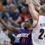 Phoenix Suns guard Brandon Knight shoots in front of Portland Trail Blazers forward Mason Plumlee during the second half of an NBA basketball game in Portland, Ore., Tuesday, Nov. 8, 2016. (AP Photo/Craig Mitchelldyer)