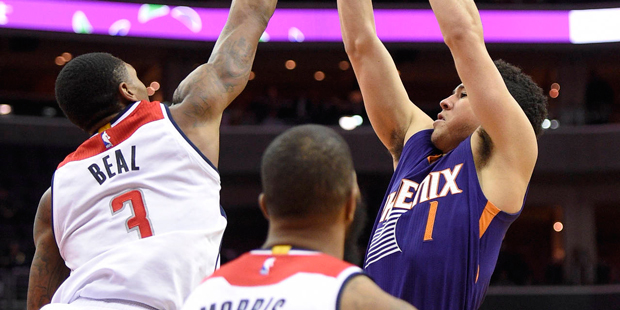 Devin Booker of the Phoenix Suns shoots over the Washington Wizards' Bradley Beal on Monday, Nov. 2...