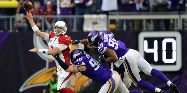 Carson Palmer is hit as he throws in the Arizona Cardinals' loss to the Minnesota Vikings on Sunday...