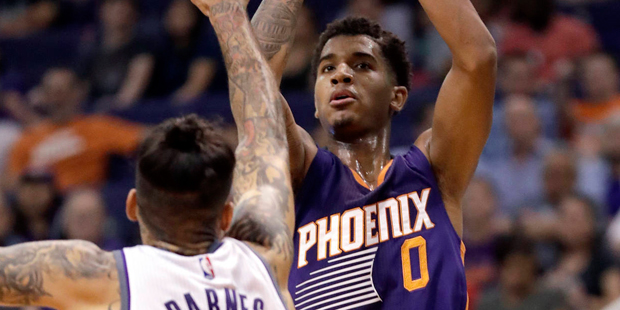 Phoenix Suns forward Marquese Chriss (0) shoots over Sacramento Kings forward Matt Barnes (22) duri...