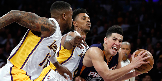 Los Angeles Lakers forward Thomas Robinson, left, and guard Nick Young, center, chase after Phoenix...