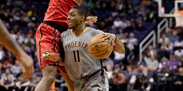 Phoenix Suns guard Brandon Knight (11) drives around Atlanta Hawks center Dwight Howard (8) during ...