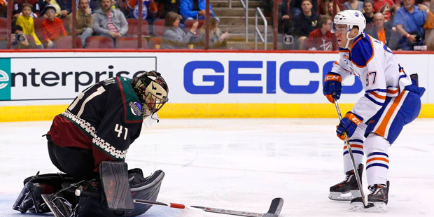 Arizona Coyotes goalie Mike Smith tries for a save against the Edmonton Oilers on Friday, Nov. 25, ...