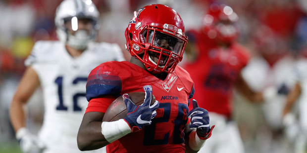 Arizona running back Nick Wilson (28) scores a touchdown against BYU during the second half of an N...