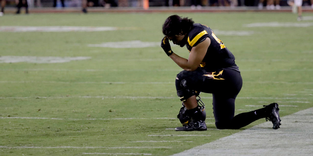 Arizona State linebacker Salamo Fiso, who was dressed but did not play, kneels on the sidelines aft...