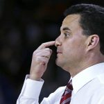 Arizona coach Sean Miller press the tip of his nose as he calls in a play during the first half against Wichita State in the first round of the NCAA college men's basketball tournament in Providence, R.I., Thursday, March 17, 2016. (AP Photo/Charles Krupa)