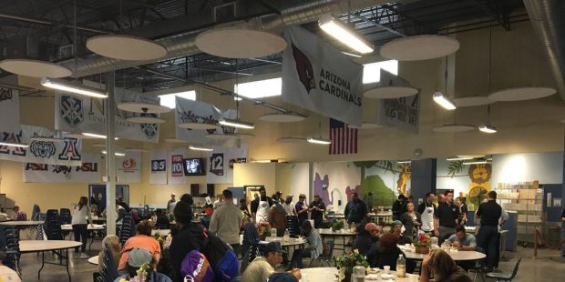 Suns employees and community members gather in the dining room at St Vincent de Paul for Thanksgivi...
