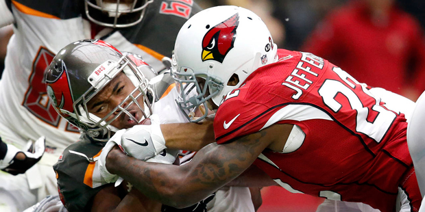 Tampa Bay Buccaneers running back Doug Martin his hit by Arizona Cardinals strong safety Tony Jeffe...