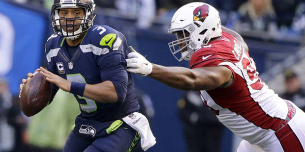 Seattle Seahawks quarterback Russell Wilson (3) is pressured by Arizona Cardinals' Calais Campbell ...