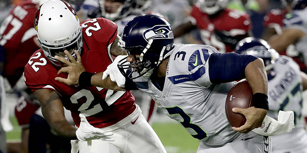 Seattle Seahawks quarterback Russell Wilson (3) blocks against Arizona Cardinals strong safety Tony...