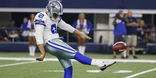 Dallas Cowboys punter Matt Wile (2) punts during the first half of a preseason NFL football game ag...