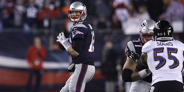 New England Patriots quarterback Tom Brady (12) sets to throw during the first half of an NFL footb...