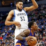 Phoenix Suns' Eric Bledsoe, right, eyes the basket as he drives by Minnesota Timberwolves' Karl-Anthony Towns during the first quarter of an NBA basketball game, Monday, Dec. 19, 2016, in Minneapolis. (AP Photo/Jim Mone)