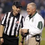 Baylor coach Jim Grobe laughs with an official during a timeout in the first half of the team's Cactus Bowl NCAA college football game against Boise State, Tuesday, Dec. 27, 2016, in Phoenix. (AP Photo/Rick Scuteri)