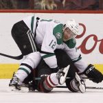 Dallas Stars' Radek Faksa (12) watches the puck as he holds down Arizona Coyotes' Martin Hanzal on a face-off during the third period of an NHL hockey game, Tuesday, Dec. 27, 2016, in Glendale, Ariz. (AP Photo/Ralph Freso)