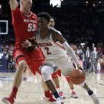 Arizona guard Kobi Simmons (2) drives on New Mexico forward Connor MacDougall during the second half of an NCAA college basketball game, Tuesday, Dec. 20, 2016, in Tucson, Ariz. (AP Photo/Rick Scuteri)
