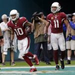 Arizona Cardinals wide receiver Brittan Golden (10) smiles after scoring a touchdown during the second half of an NFL football game against the Miami Dolphins, Sunday, Dec. 11, 2016, in Miami Gardens, Fla. To the right is Arizona Cardinals wide receiver Larry Fitzgerald (11). (AP Photo/Lynne Sladky)
