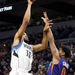 Minnesota Timberwolves' Karl-Anthony Towns, left, lays up over Phoenix Suns forward Marquese Chriss during the second half of an NBA basketball game, Monday, Dec. 19, 2016, in Minneapolis. The Timberwolves won 105-108. Towns led the Timberwolves with 28 points and 15 rebounds. (AP Photo/Jim Mone)