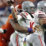 Ohio State quarterback J.T. Barrett (16) is hit by Clemson defensive tackle Dexter Lawrence during the first half of the Fiesta Bowl NCAA college football game, Saturday, Dec. 31, 2016, in Glendale, Ariz. (AP Photo/Ross D. Franklin)