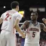 Arizona guard Kadeem Allen (5) and Chance Comanche (21) celebrate after defeating New Mexico 77-46 during an NCAA college basketball game, Tuesday, Dec. 20, 2016, in Tucson, Ariz. (AP Photo/Rick Scuteri)