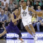 Phoenix Suns guard Devin Booker (1) defends against Utah Jazz center Boris Diaw (33) in the first half of an NBA basketball game, Tuesday, Dec. 6, 2016, in Salt Lake City. (AP Photo/Rick Bowmer)
