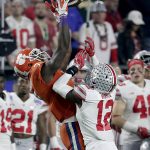 Clemson wide receiver Mike Williams (7) pulls in a catch as Ohio State cornerback Denzel Ward (12) defends during the first half of the Fiesta Bowl NCAA college football playoff game, Saturday, Dec. 31, 2016, in Glendale, Ariz. (AP Photo/Rick Scuteri)