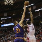 Houston Rockets guard James Harden (13) drives to the basket as Phoenix Suns center Alex Len (21) defends in the first half of an NBA basketball game on Monday, Dec. 26, 2016 in Houston. (AP Photo/Bob Levey)