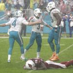 Miami Dolphins tackle Ja'Wuan James (70) and punter Matt Darr (4) congratulate Miami Dolphins kicker Andrew Franks (3, after Franks scored a field goal to win the game, during the second half of an NFL football game, Sunday, Dec. 11, 2016, in Miami Gardens, Fla. To the bottom is Arizona Cardinals cornerback Justin Bethel (28). The Dolphins defeated the Cardinals 26-23. (AP Photo/Wilfredo Lee)