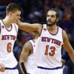 New York Knicks center Joakim Noah (13) pats New York Knicks forward Kristaps Porzingis (6) on the head after a defensive stop during the first half of an NBA basketball game against the Phoenix Suns, Tuesday, Dec. 13, 2016, in Phoenix. (AP Photo/Ross D. Franklin)