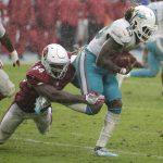 Arizona Cardinals inside linebacker Sio Moore (54) tackles Miami Dolphins running back Jay Ajayi (23), during the second half of an NFL football game, Sunday, Dec. 11, 2016, in Miami Gardens, Fla. The Dolphins defeated the Cardinals 26-23. (AP Photo/Wilfredo Lee)