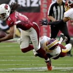 Arizona Cardinals wide receiver Larry Fitzgerald (11) is hit by Washington Redskins inside linebacker Su'a Cravens (36) during the first half of an NFL football game, Sunday, Dec. 4, 2016, in Glendale, Ariz. (AP Photo/Rick Scuteri)