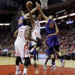 Houston Rockets center Nene (42) drives between Phoenix Suns forward Dragan Bender (35) and center Alex Len (21) for a layup as James Harden (13) looks on in the first half of an NBA basketball game on Monday, Dec. 26, 2016 in Houston. (AP Photo/Bob Levey)