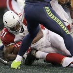 Arizona Cardinals' David Johnson (31) scores his second one-yard run touchdown against the Seattle Seahawks during the second half of an NFL football game, Saturday, Dec. 24, 2016, in Seattle. (AP Photo/John Froschauer)