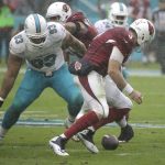 Arizona Cardinals quarterback Carson Palmer (3) fumbles the ball as Miami Dolphins defensive tackle Ndamukong Suh (93) attempts to recover it, during the first half of an NFL football game, Sunday, Dec. 11, 2016, in Miami Gardens, Fla. (AP Photo/Wilfredo Lee)