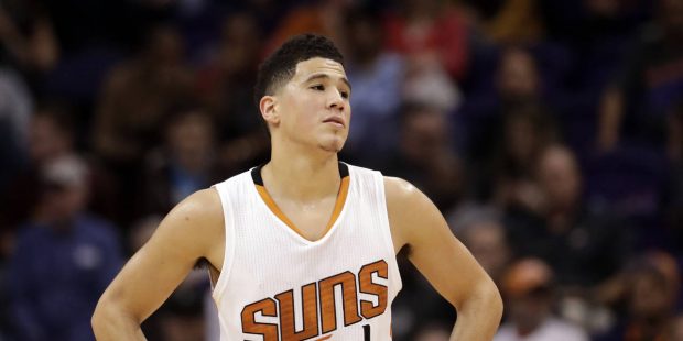 Phoenix Suns guard Devin Booker pauses during a stop in play in the second half of the team's NBA b...