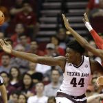 Texas A&M's Robert Williams (44) loses the ball as Arizona's Kobi Simmons (2) defend during the first half of an NCAA college basketball game, Saturday, Dec. 17, 2016, in Houston. (AP Photo/David J. Phillip)