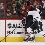Arizona Coyotes' Martin Hanzal (11) and Dallas Stars' Jamie Oleksiak compete for a loose puck along the boards during the first period of an NHL hockey game, Tuesday, Dec. 27, 2016, in Glendale, Ariz. (AP Photo/Ralph Freso)