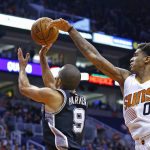 Phoenix Suns forward Marquese Chriss (0) blocks the shot of San Antonio Spurs guard Tony Parker (9) during the first half of an NBA basketball game Thursday, Dec. 15, 2016, in Phoenix. (AP Photo/Ross D. Franklin)