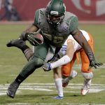 Baylor running back Terence Williams (22) is tripped up by Boise State safety Kekoa Nawahine (10) during the first half of the Cactus Bowl NCAA college football game, Tuesday, Dec. 27, 2016, in Phoenix. (AP Photo/Rick Scuteri)