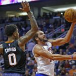 New York Knicks center Joakim Noah, right, gets fouled by Phoenix Suns forward Marquese Chriss (0) as Noah goes up for a shot during the first half of an NBA basketball game Tuesday, Dec. 13, 2016, in Phoenix. (AP Photo/Ross D. Franklin)