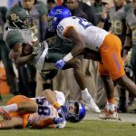 Baylor wide receiver KD Cannon, center, is hit by Boise State cornerback Raymond Ford (25) and linebacker Tyson Maeva (58) during the first half of the Cactus Bowl NCAA college football game, Tuesday, Dec. 27, 2016, in Phoenix. (AP Photo/Rick Scuteri)