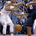 San Antonio Spurs forward Kawhi Leonard (2) is fouled as he goes to shoot by Phoenix Suns forward P.J. Tucker, left, during the first half of an NBA basketball game Thursday, Dec. 15, 2016, in Phoenix. (AP Photo/Ross D. Franklin)